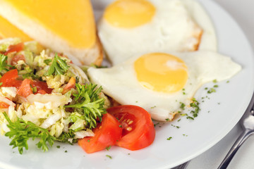 Tasty brekfast. Fried eggs with salad and toast