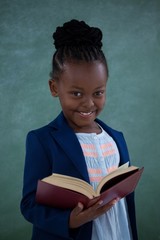 Portrait of smiling businesswoman holding book