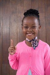 Portrait of smiling little girl dressed as businesswoman