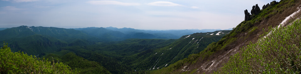Fototapeta na wymiar Panoramic view on green slopes around Mount Kurodake, Daisetsuzan National Park, Hokkaido, Japan