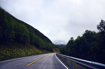 Empty road in Norway on a clouded summer day