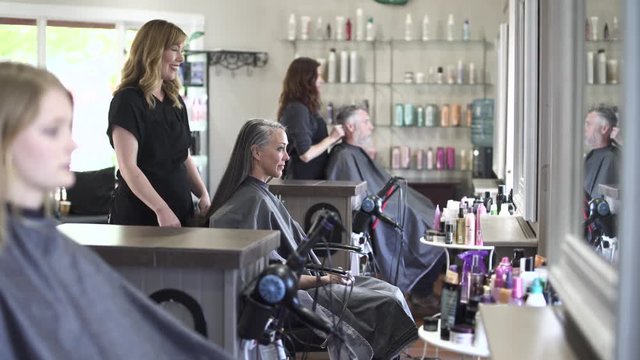 Medium shot of a hairdresser at work