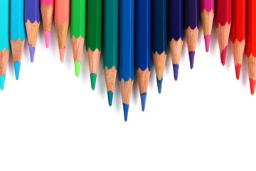 Multicolor bright color pencils horizontal wave on white background pointing downward