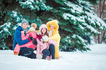 Happy family enjoy winter snowy day