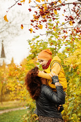 Autumn Family. Loving Mother and Son  in Fall Park Outdoors