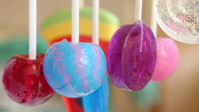 colorful lollipops hang in the air. 4k slow motion