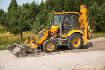 Obraz na płótnie Canvas Construction of stationary and temporary roads, a tractor