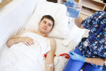 Obraz na płótnie Canvas A nurse injects a patient with a vein