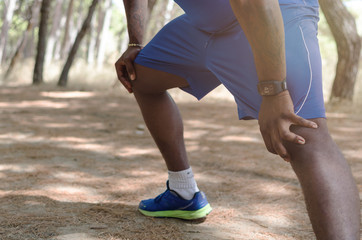 Black man doing leg exercise in nature
