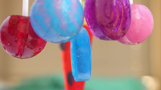 colorful lollipops hang in the air. 4k slow motion
