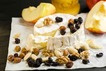 Camembert cheese with nuts, fruit and honey