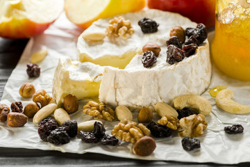 Camembert cheese with nuts, fruit and honey