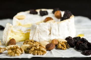 Camembert cheese with nuts, fruit and honey