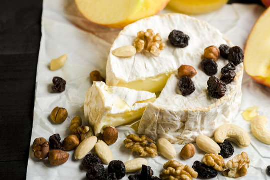 Camembert cheese with nuts, fruit and honey