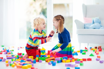 Kids play with toy blocks. Toys for children.