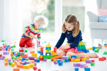 Kids play with toy blocks. Toys for children.