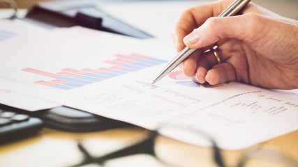 Hand Checking Financial Documents