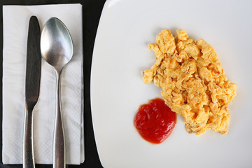 Scrambled eggs on a plate.