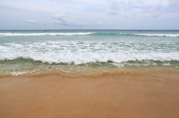 Fototapeta na wymiar Ocean wave on sandy beach.