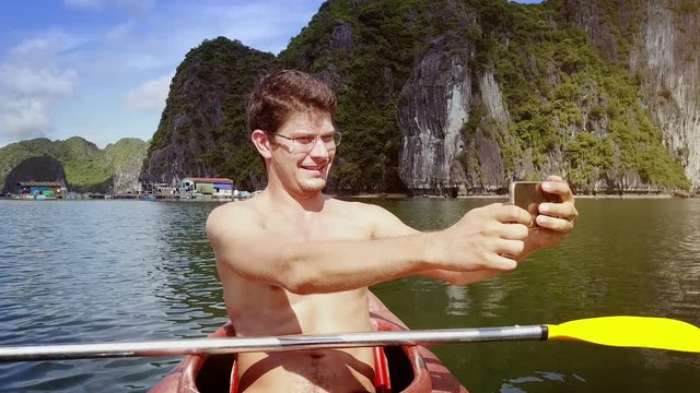 Man Makes Selfie in Kayak against Wonderful Steep Cliffs