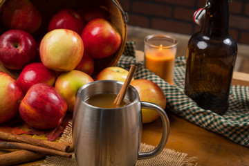 Apple cider with apples and stainless cup