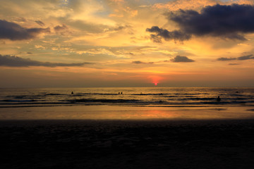 Silhouette people at the sunset beach with orange sky with beautiful blue, evening time.