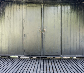Vintage Thai wooden wall, floor and door with lock. Old house with black paint in Thailand.