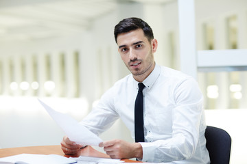 Young confident business leader in shirt and tie making news report