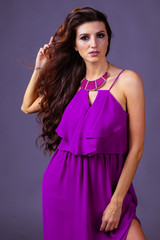 Obraz premium beautiful girl with long hair in purple dress
