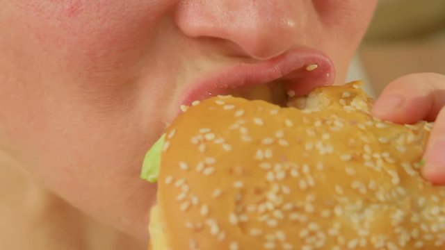 Closeup Of A Woman Eating A Big Apetit Burger