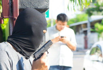 Close up back view of bandit catch a hidden gun,A man holding a gun in his hand behind his back, close-up view