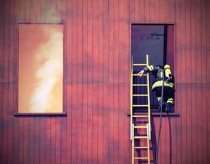 firefighter with a long ladder with the mask and the oxygen cyli