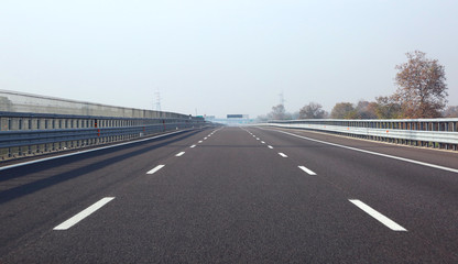 long highway with three lane without cars