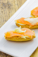 Fototapeta na wymiar Tasty appetizer of salmon canapes