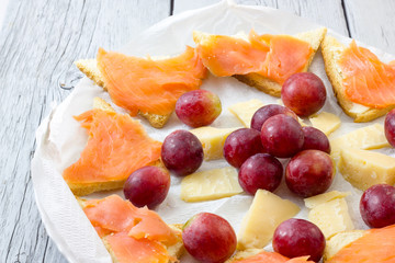 Salmon appetizer with grapes and cheese