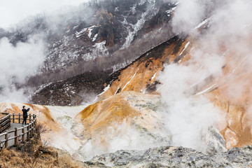 Noboribetsu Jigokudani (Hell Valley): The volcano valley with sulfuric smell, extremely high heat and steam spouting out of the ground in Hokkaido, Japan.