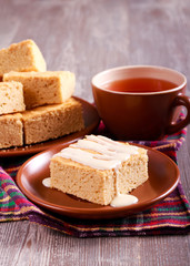 Blondies with glaze, served on plate