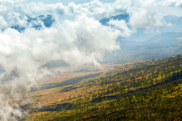 Mountain landscape in the clouds. View from above. Trekking on the volcano of Rinjani. Indonesia.