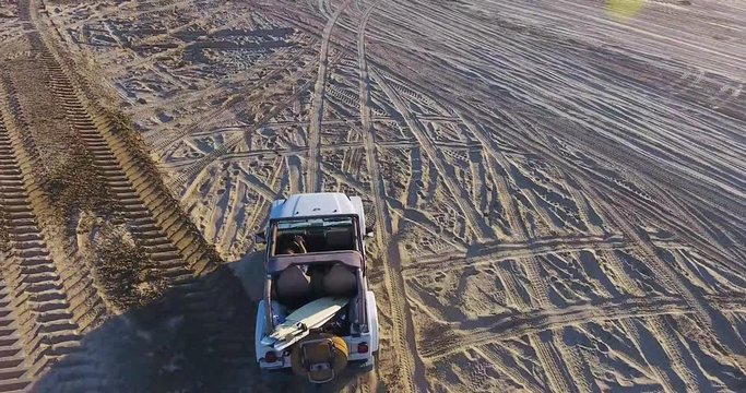 Drone actively following a Jeep on the beach