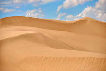 Fototapeta na wymiar Sand dunes of Asia. In physical geography, a dune is a hill of loose sand built by wind or the flow of water.