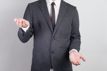 Young man giving empty hand on black background.Hands open businessman. some object are here.