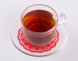 Tea in glass cup or glass cup of black tea on a background.
