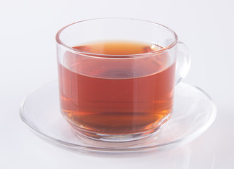 Tea in glass cup or glass cup of black tea on a background.