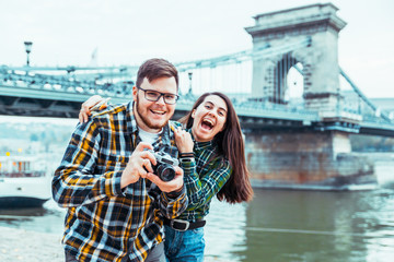 lovely cople taking picture bridge on background