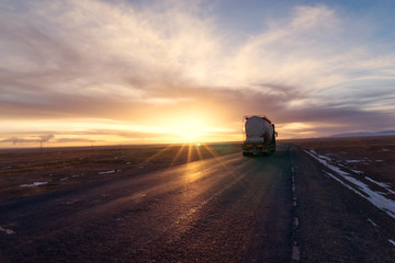 traffic on country road with sunbeam