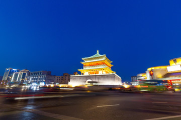 busy road and old style architecture at night