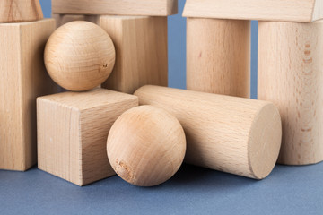 wooden geometric shapes on a blue