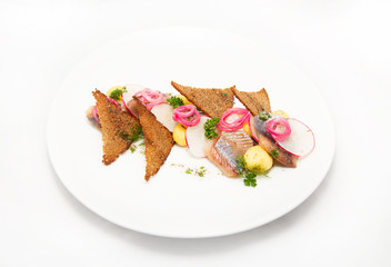 Plate of omul fish with bread and onion on white