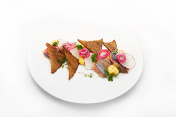 Plate of omul fish with bread and onion on white