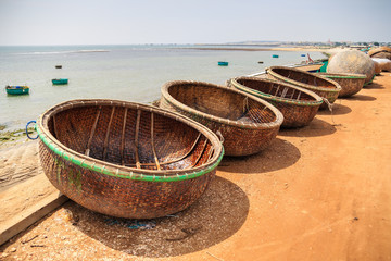 Idle basket boat on the beach in Tuy Phong, Binh Thuan, Vietnam. Tuy Phong district also has other beautiful landscapes, such as Ghenh Son, Nam Hai Tomb, and yellow sand dunes